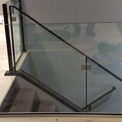 Glass and black metal railing along a staircase.