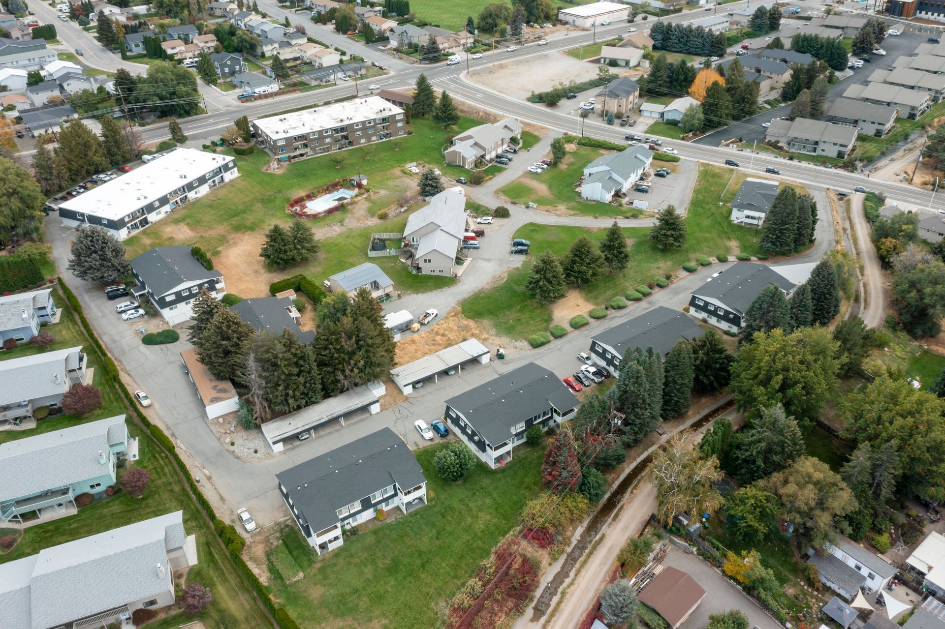 An aerial view of a residential area with lots of houses and trees.