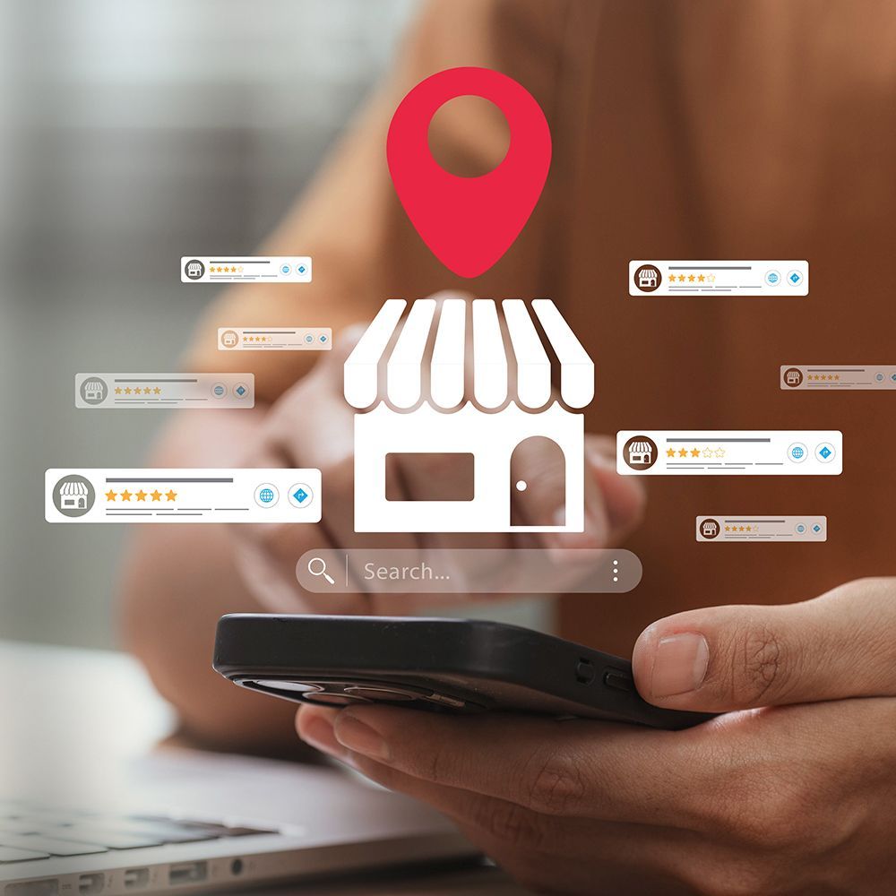 Hand holding smartphone with glowing store location icon and floating review cards over blurred background