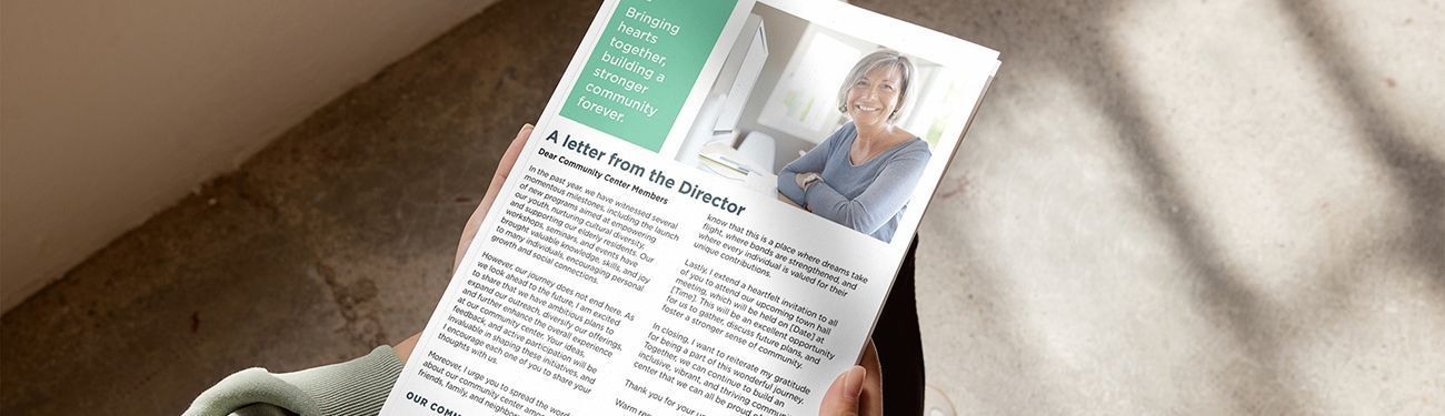 A person is holding a piece of paper with a picture of a man on it.