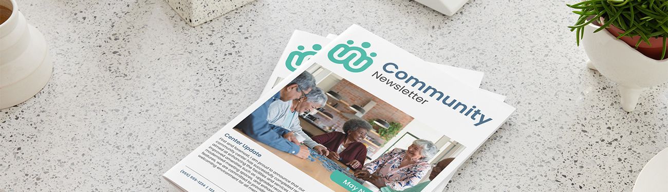 A magazine is sitting on a table next to a plant.