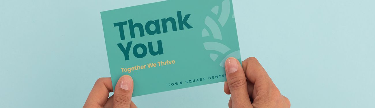 A person is holding a thank you card in their hands.