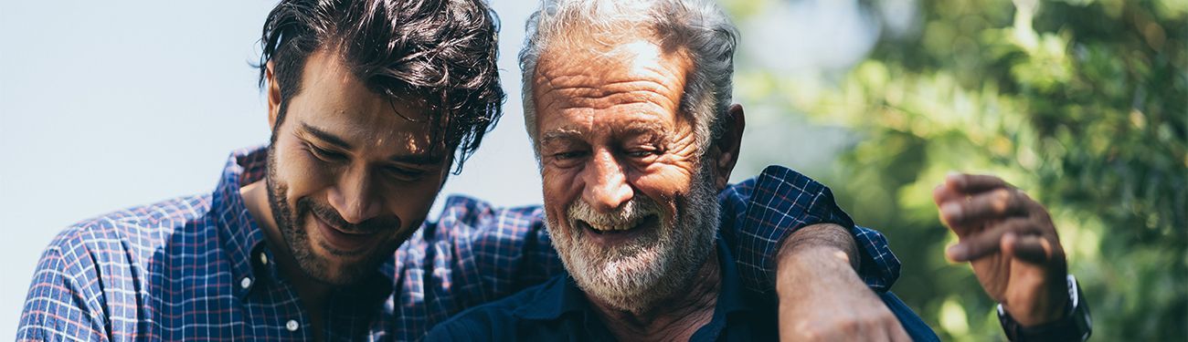 Two men , one older and one younger , are standing next to each other.