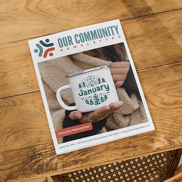A person is holding a mug on the cover of a newsletter.