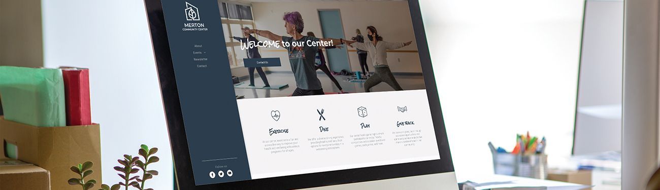 A computer monitor is sitting on a desk in front of a window.