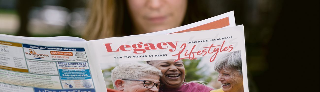 A woman is reading a community newsletter.