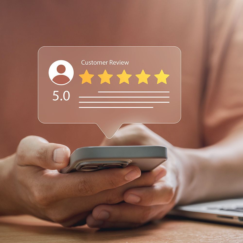 Star rating overlay on a person using a smartphone, with five yellow stars 