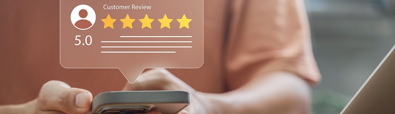Star rating overlay on a person using a smartphone, with five yellow stars 