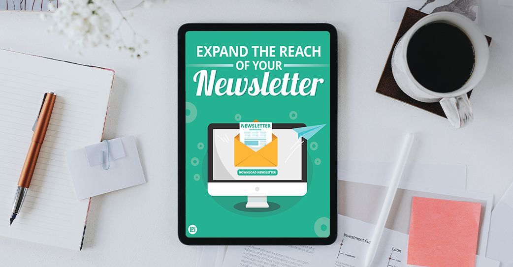 A tablet is sitting on a desk next to a cup of coffee.