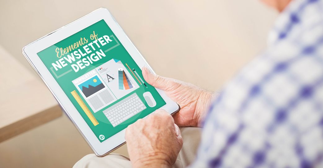 A man is holding a tablet with a newsletter on it.