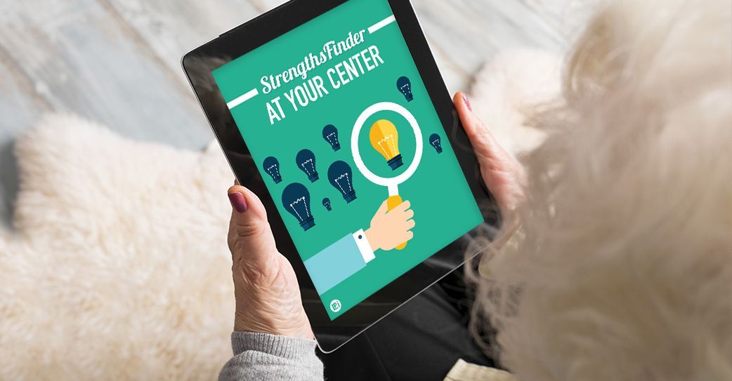 A person is holding a tablet with a magnifying glass on it.