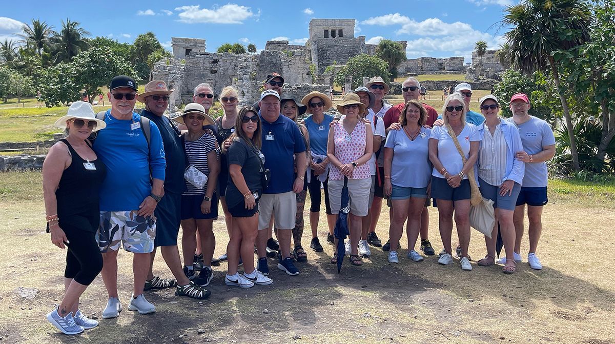 A group of people are posing for a picture in a field.