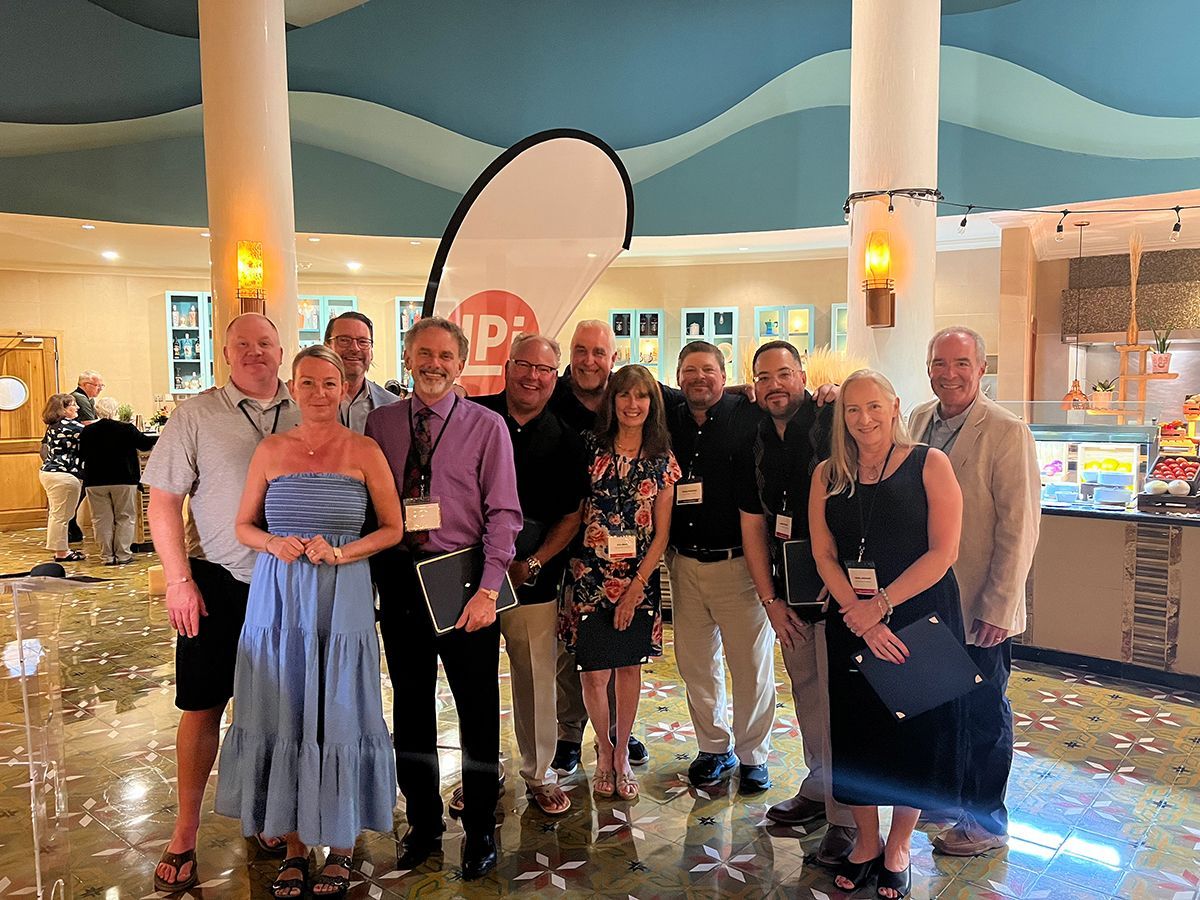 A group of people are posing for a picture in a lobby.