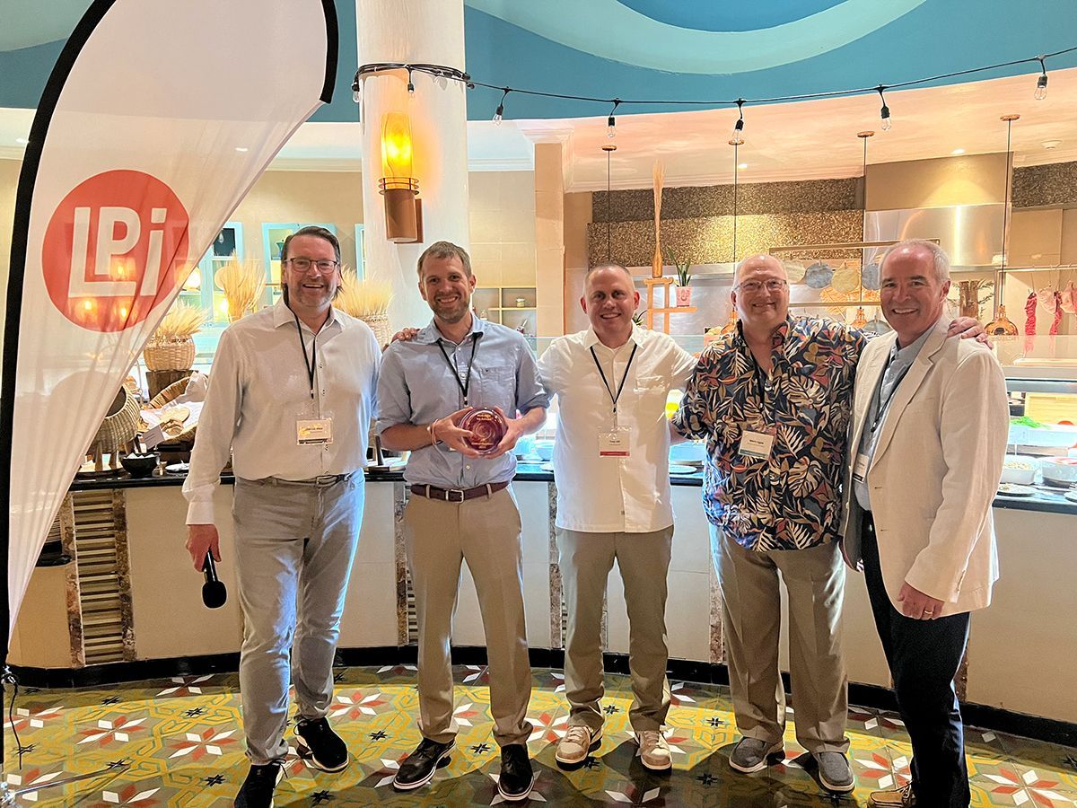 A group of men are standing next to each other in a room.