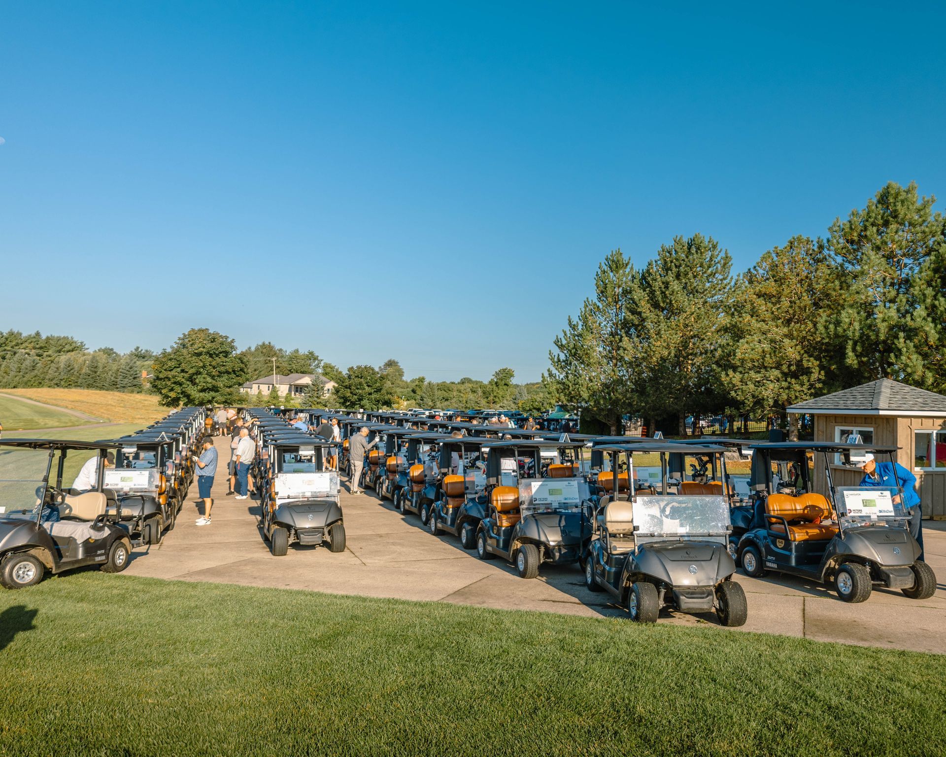 a group of men are posing for a picture on a golf course .
