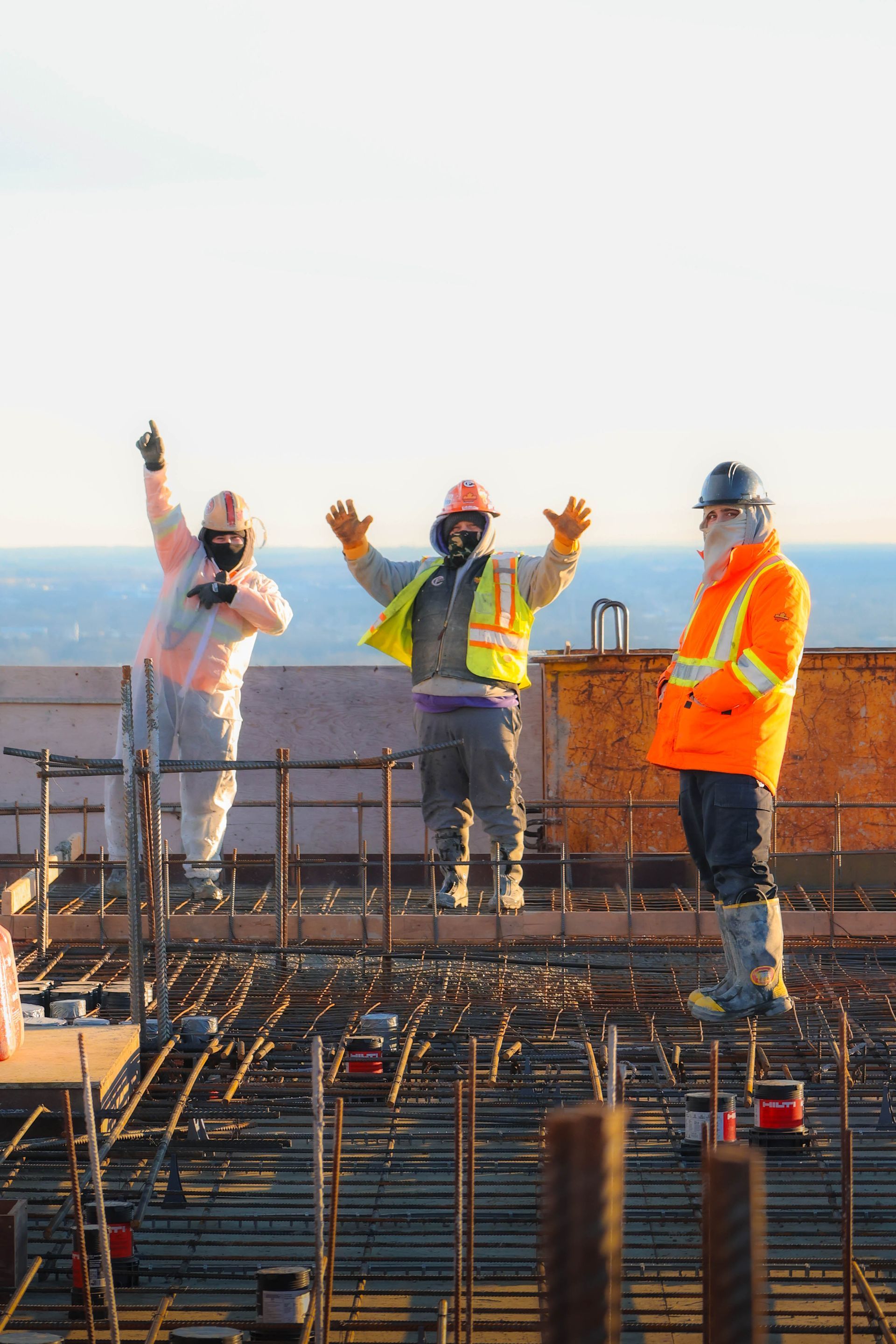 a group of construction workers standing on top of a construction site