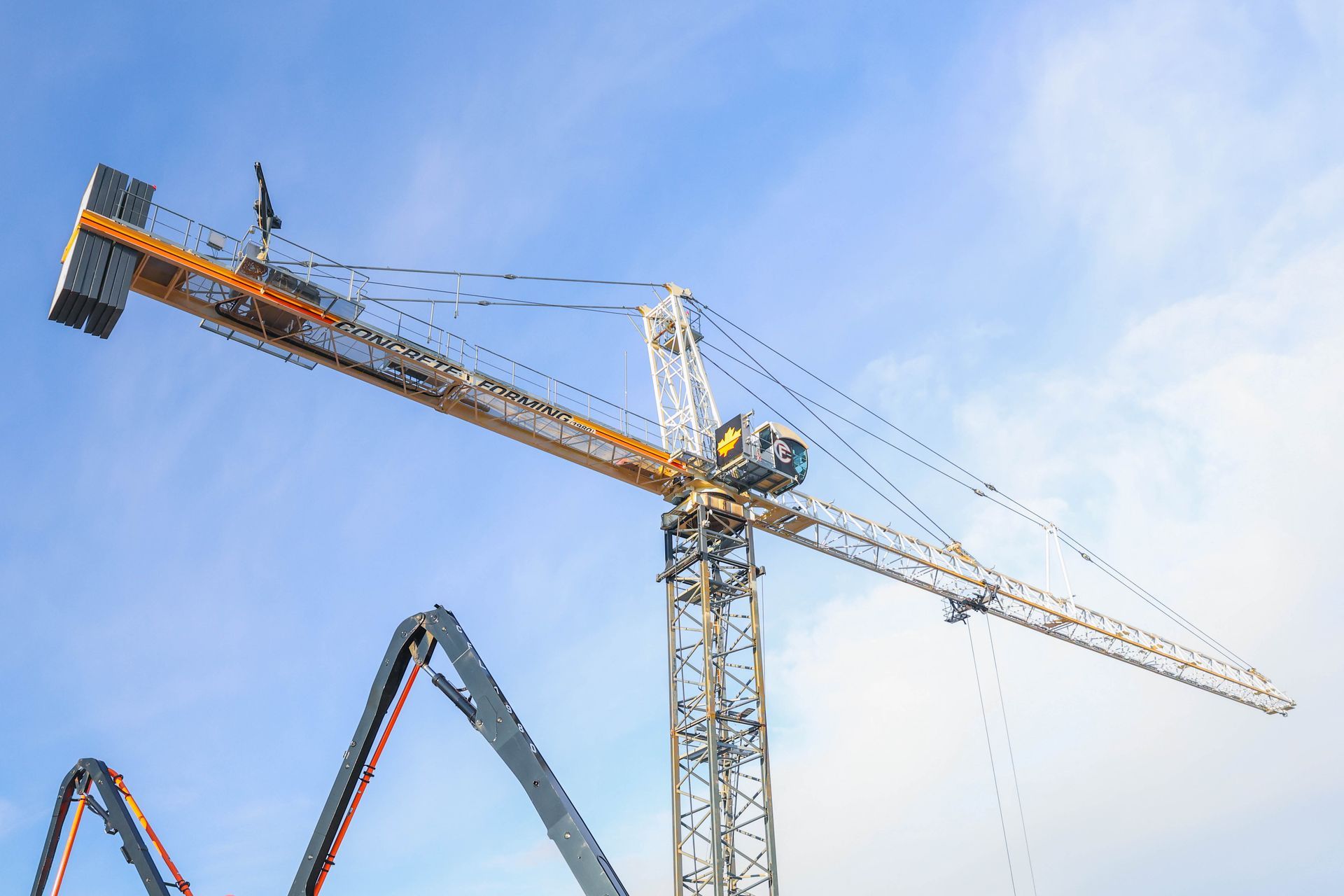 a construction crane is being used to pump concrete at a construction site .