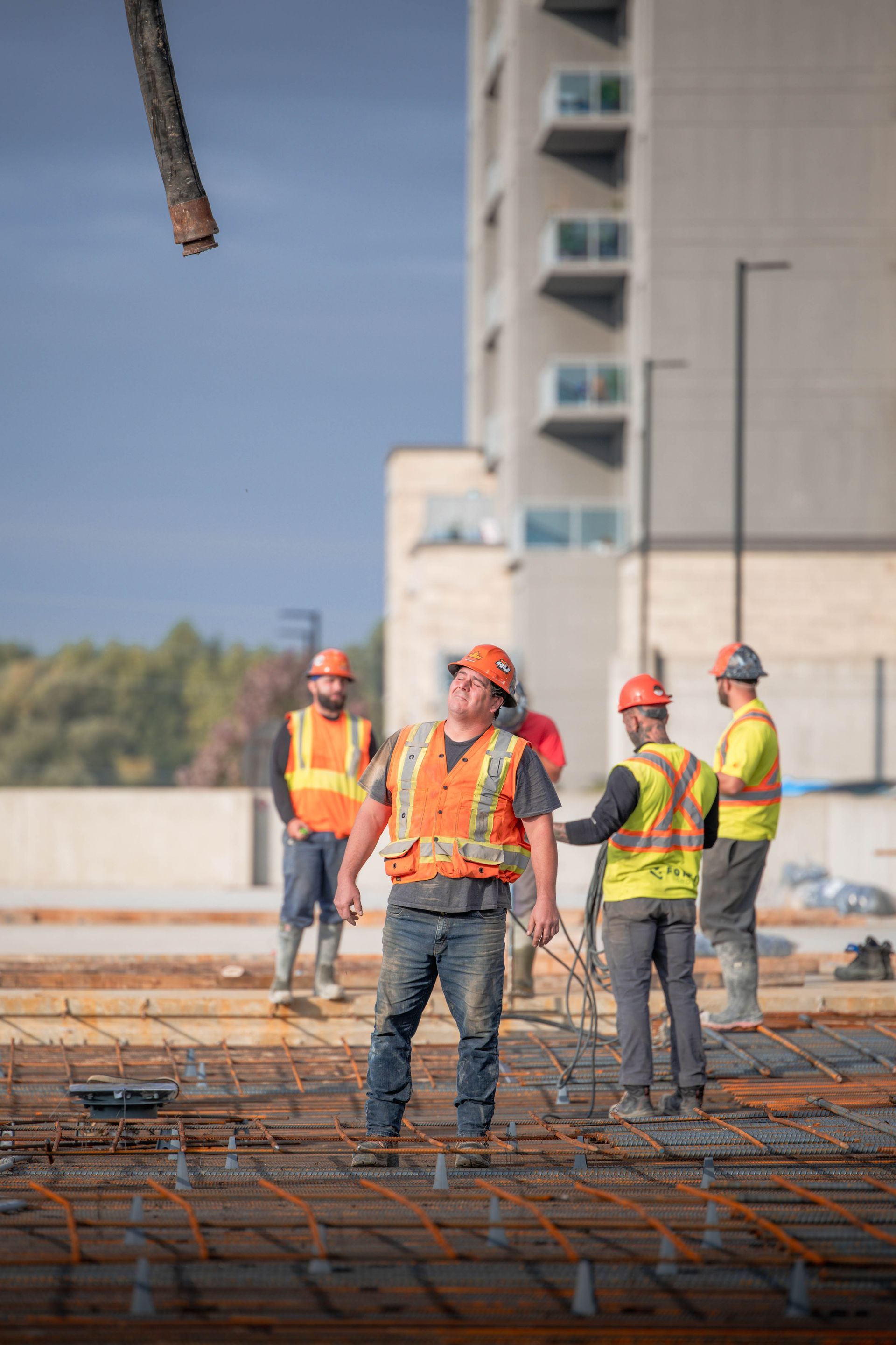 a group of construction workers are standing on a construction site .
