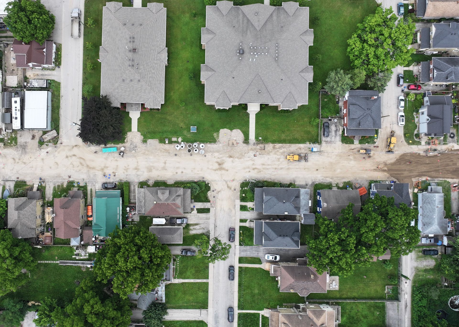 An aerial view of a city with a lot of trees and houses.