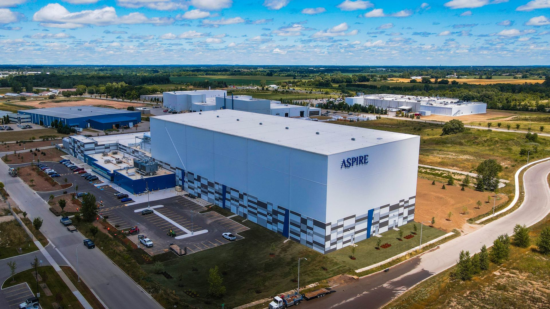 an aerial view of a large white building in the middle of a city .