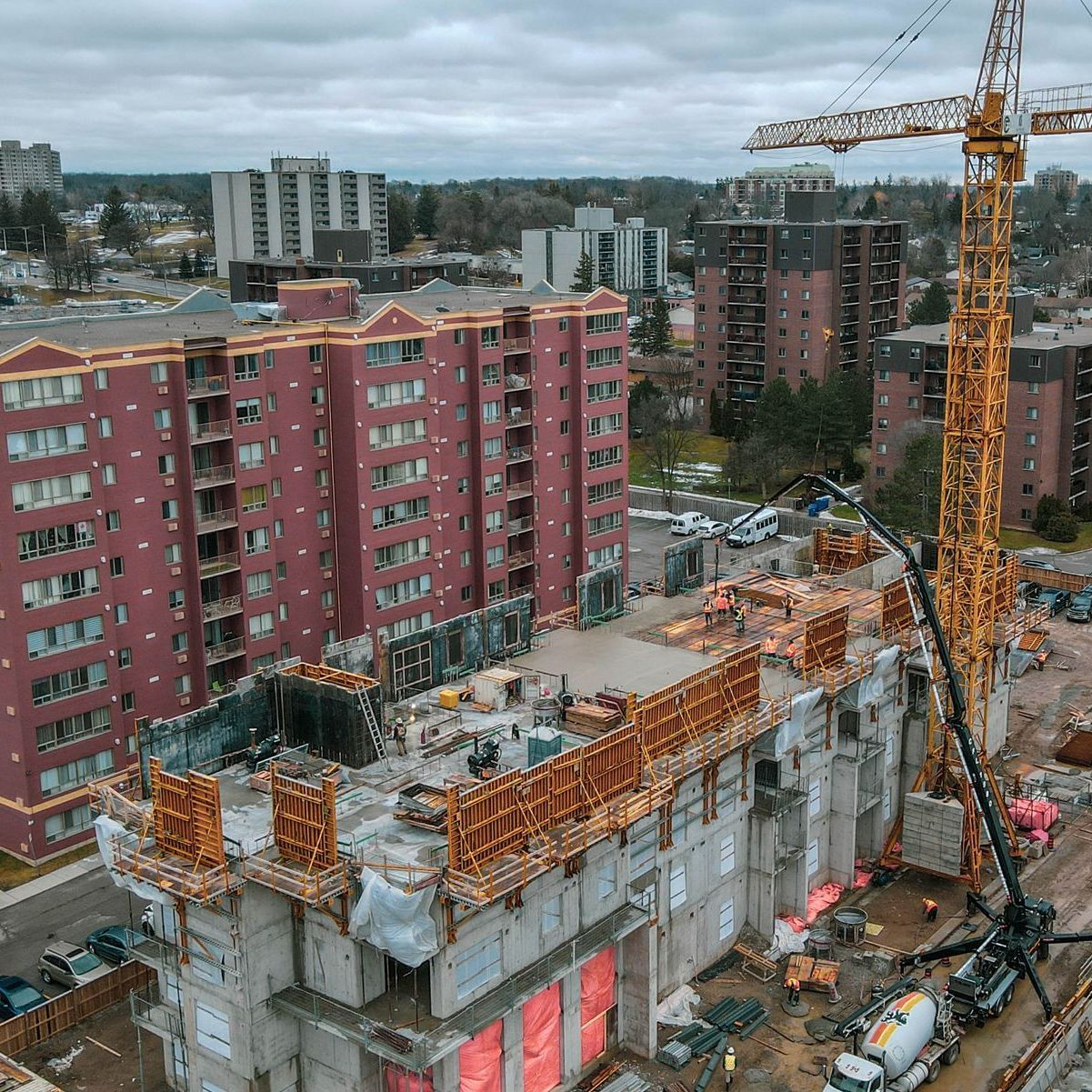 An aerial view of a building under construction in a city.