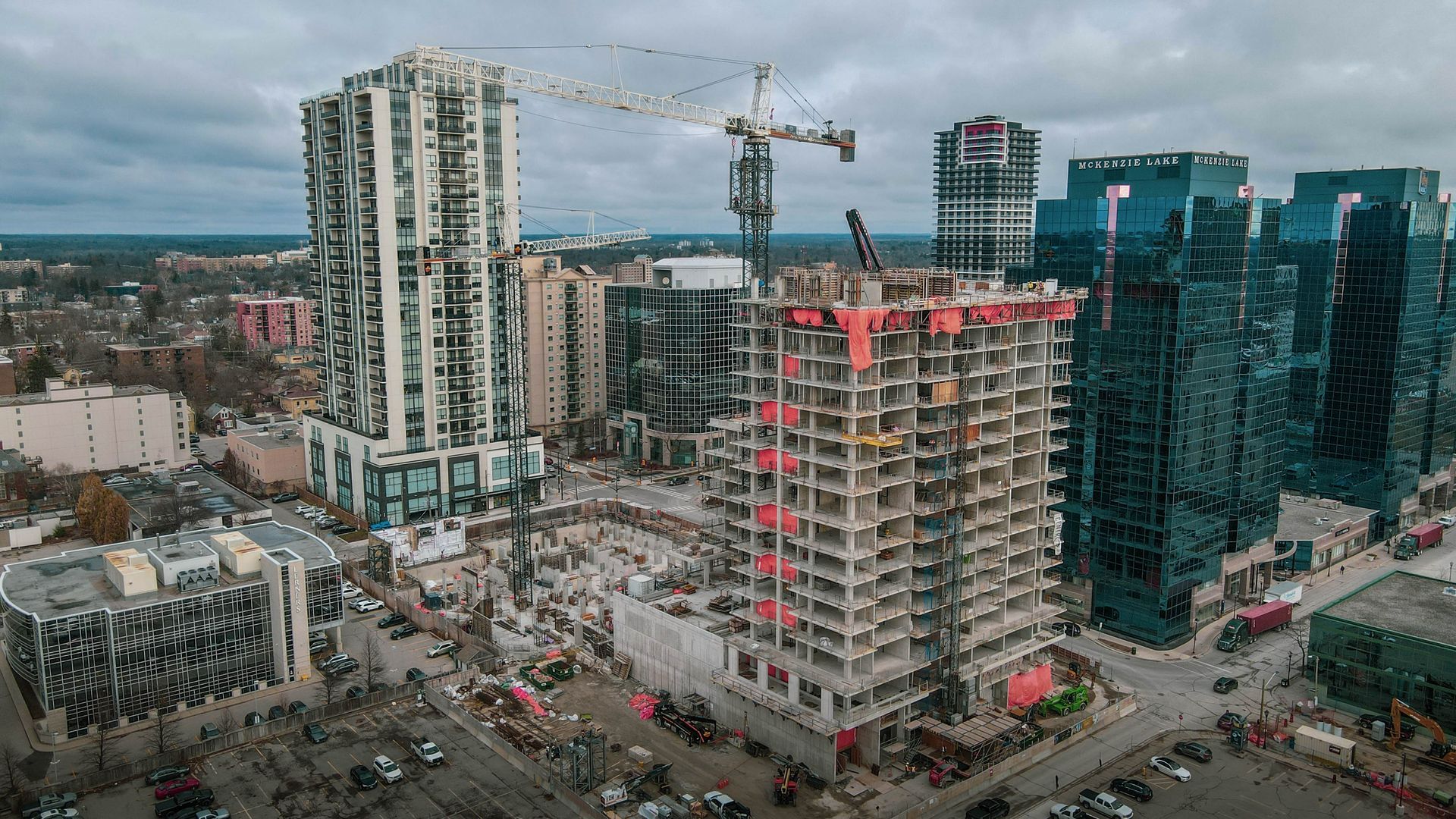 an aerial view of a city with a lot of tall buildings under construction .