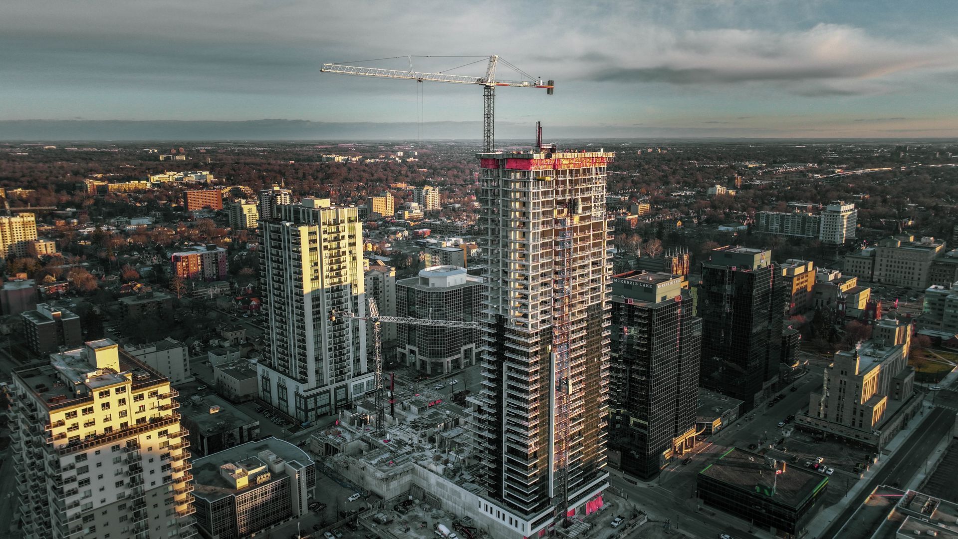 an aerial view of a city at night with a tall building under construction .
