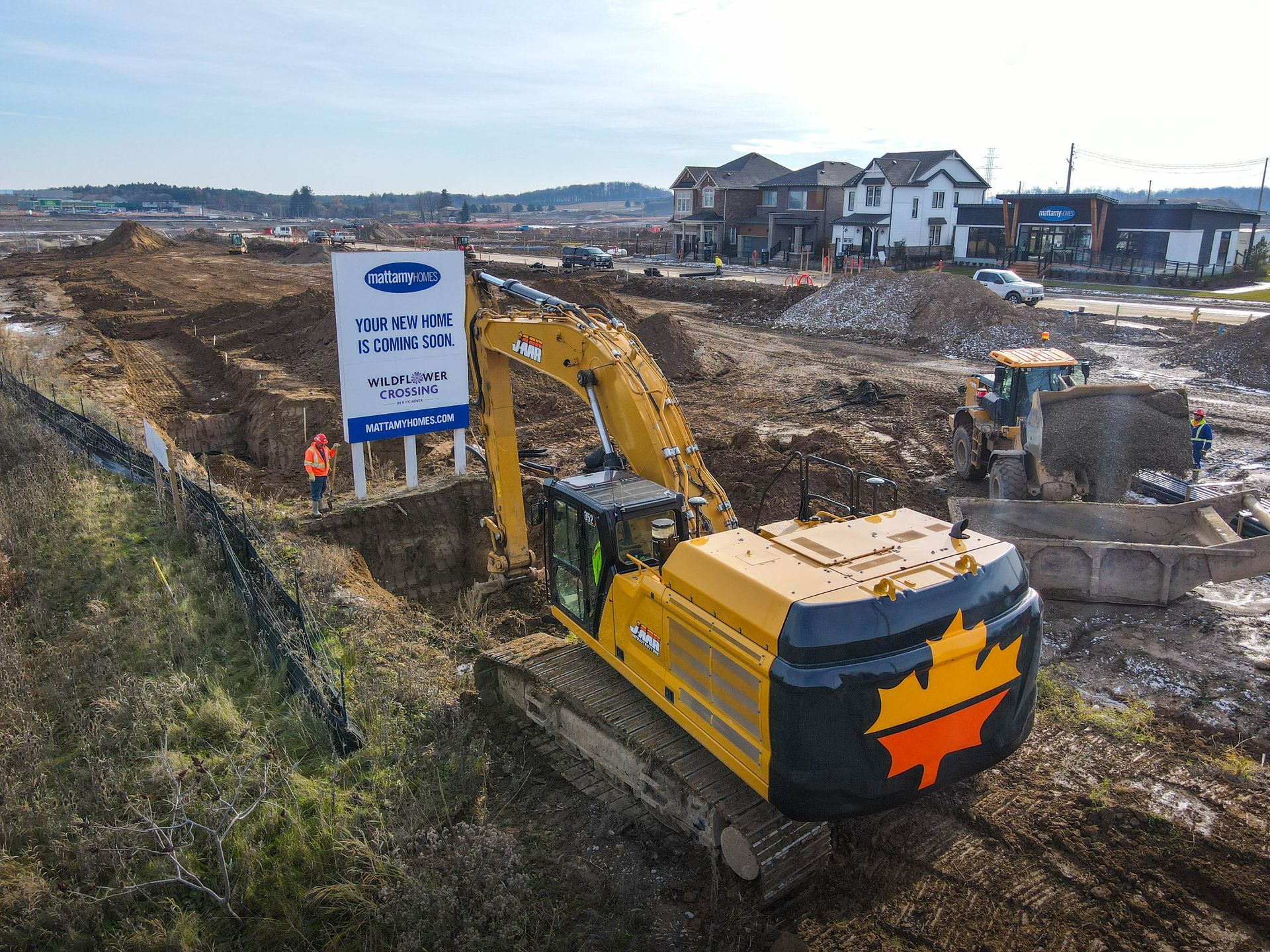 An aerial view of a construction site with a large excavator.