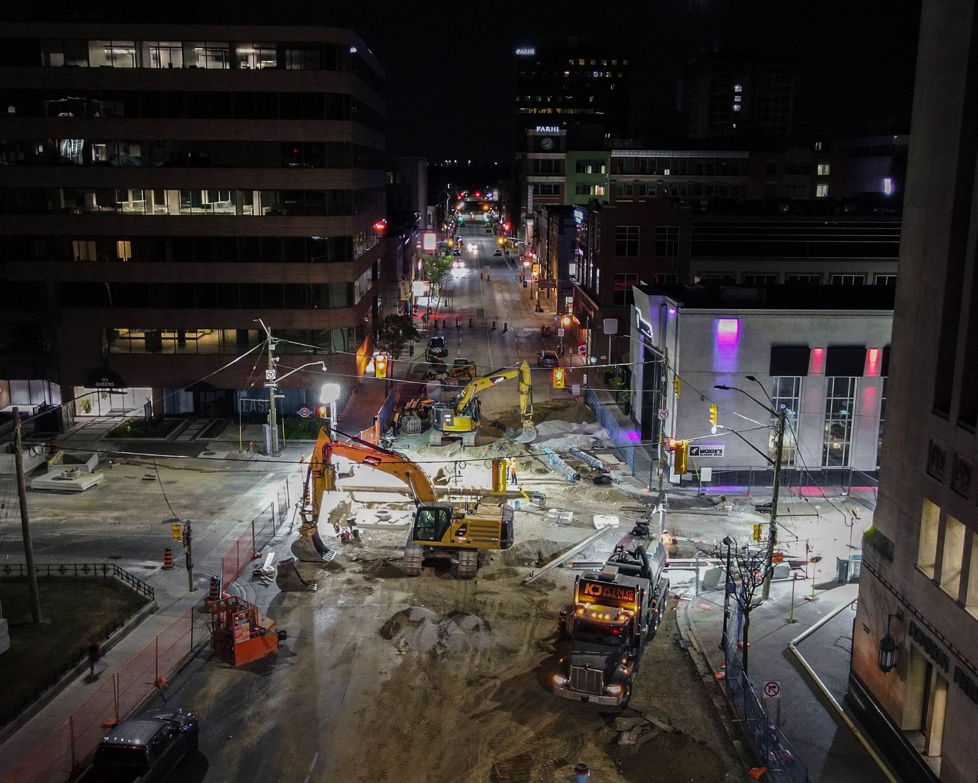 An aerial view of a construction site in a city at night.