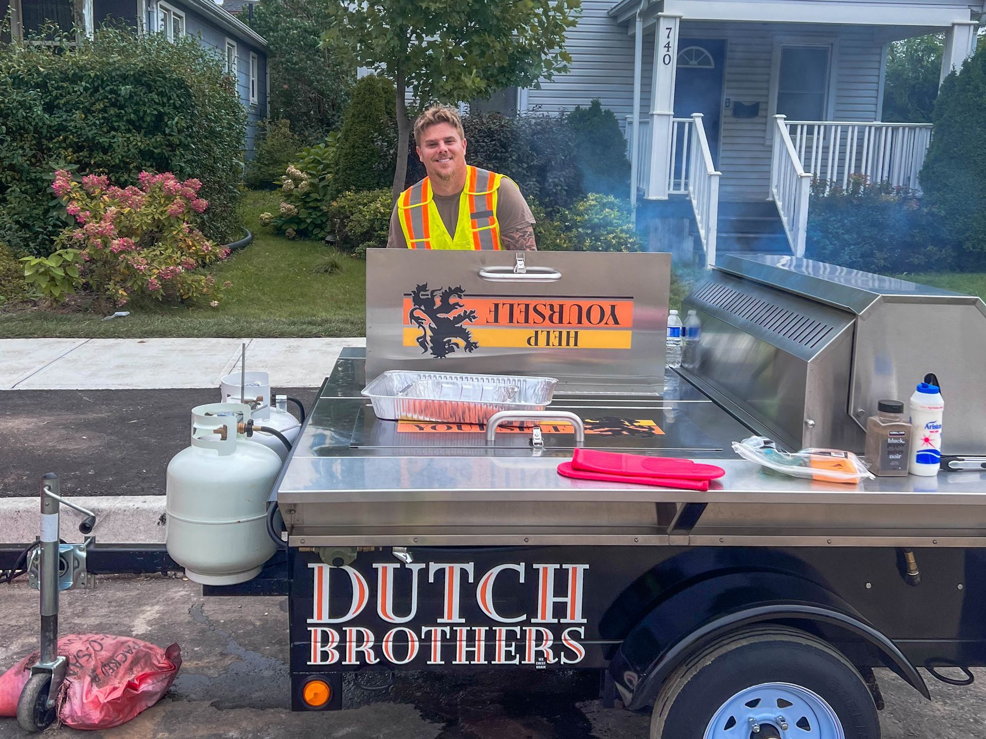 a man is standing in front of J-AAR bbq for on-site BBQ