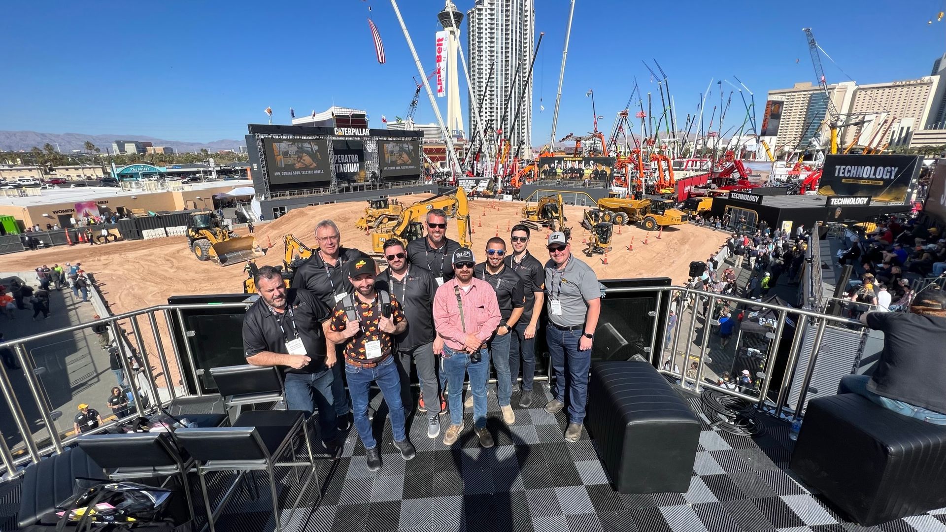 J-AAR Employees are posing for a picture on a stage .