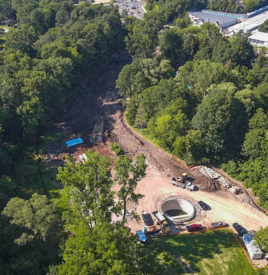 an aerial view of a construction site in the middle of a forest