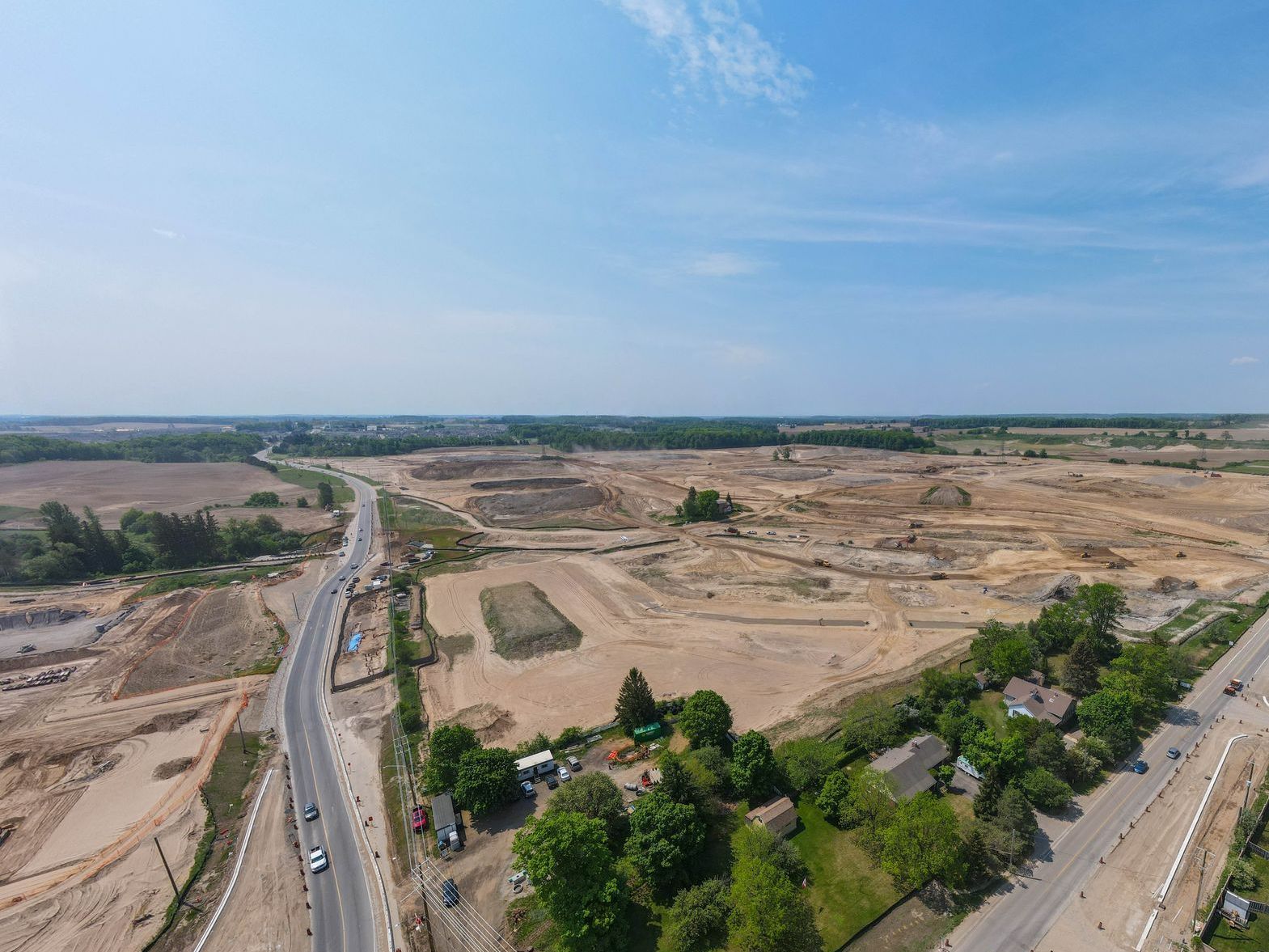 An aerial view of a construction site with a road going through it.