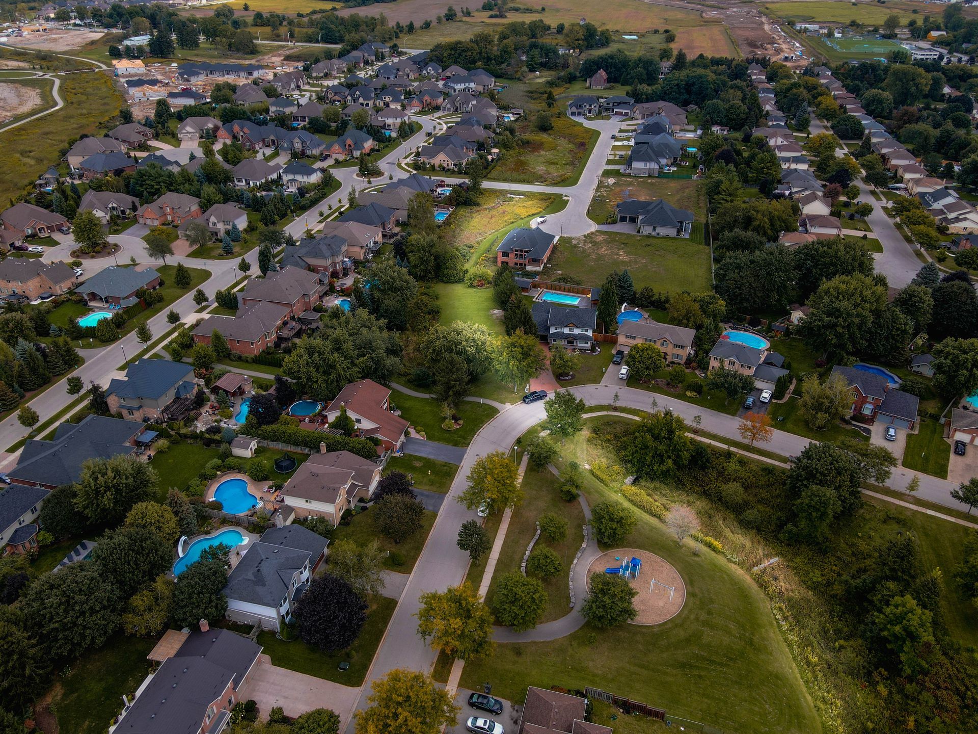 An aerial view of a residential neighborhood with lots of houses and trees.