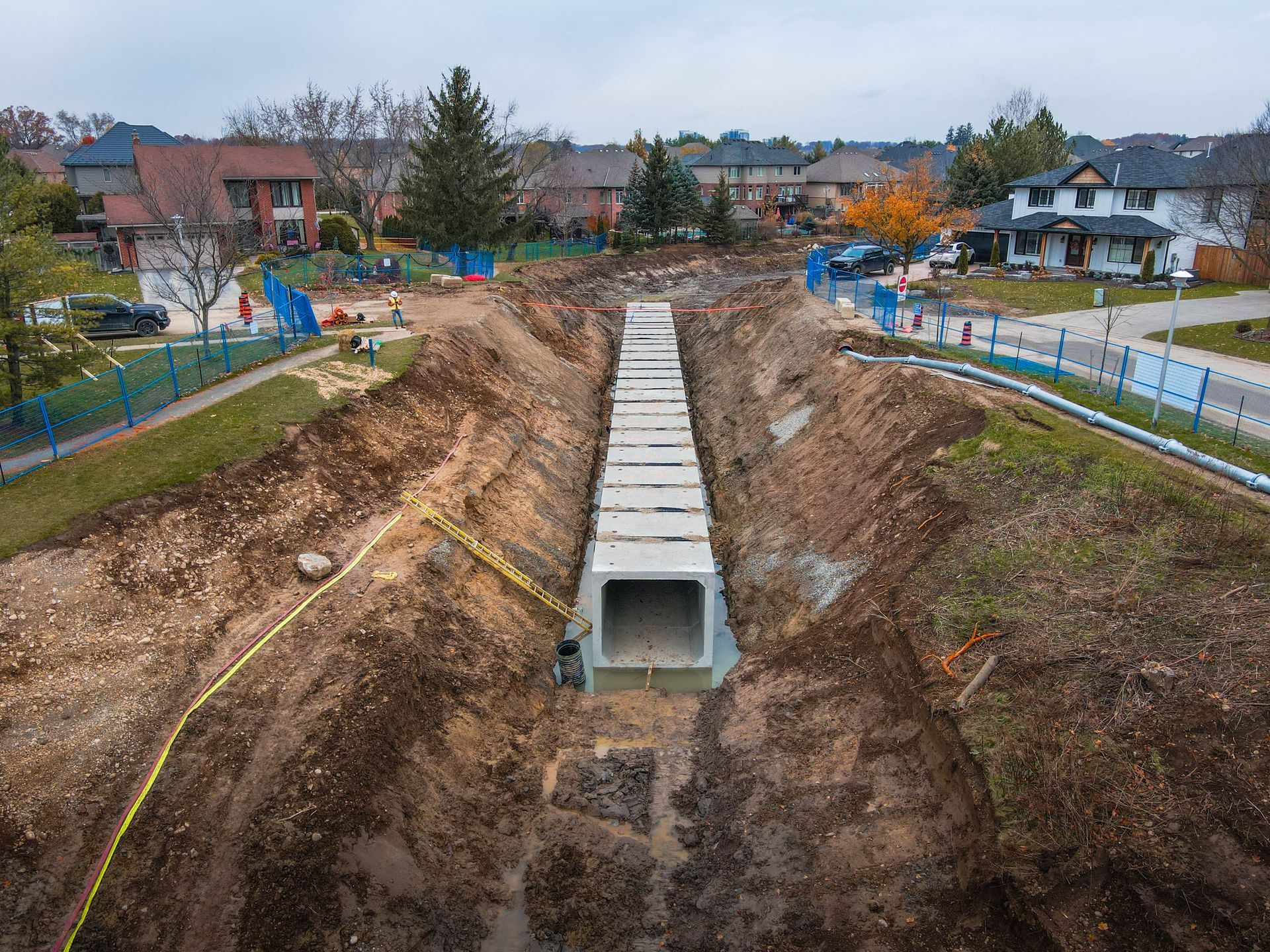 An aerial view of a construction site in a residential area.