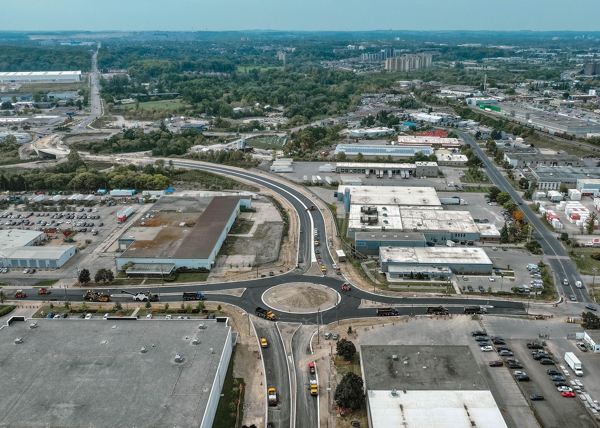 An aerial view of a busy intersection with a roundabout in the middle.