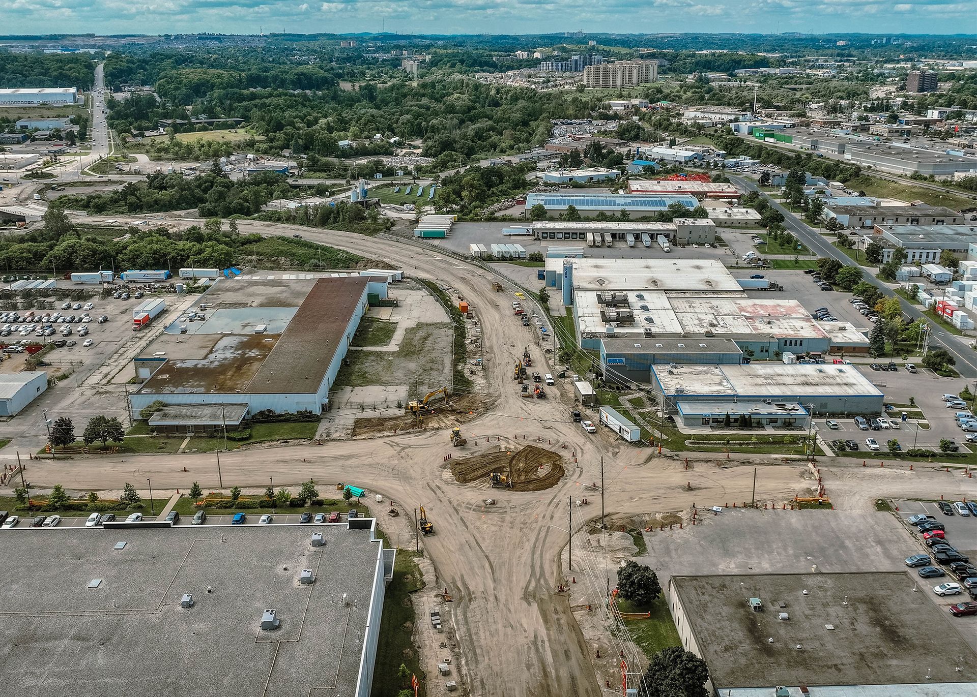 An aerial view of a highway intersection with a store in the middle of it.