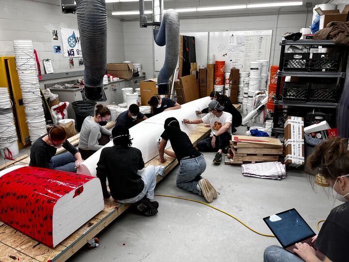 a group of people are working on a project in a room