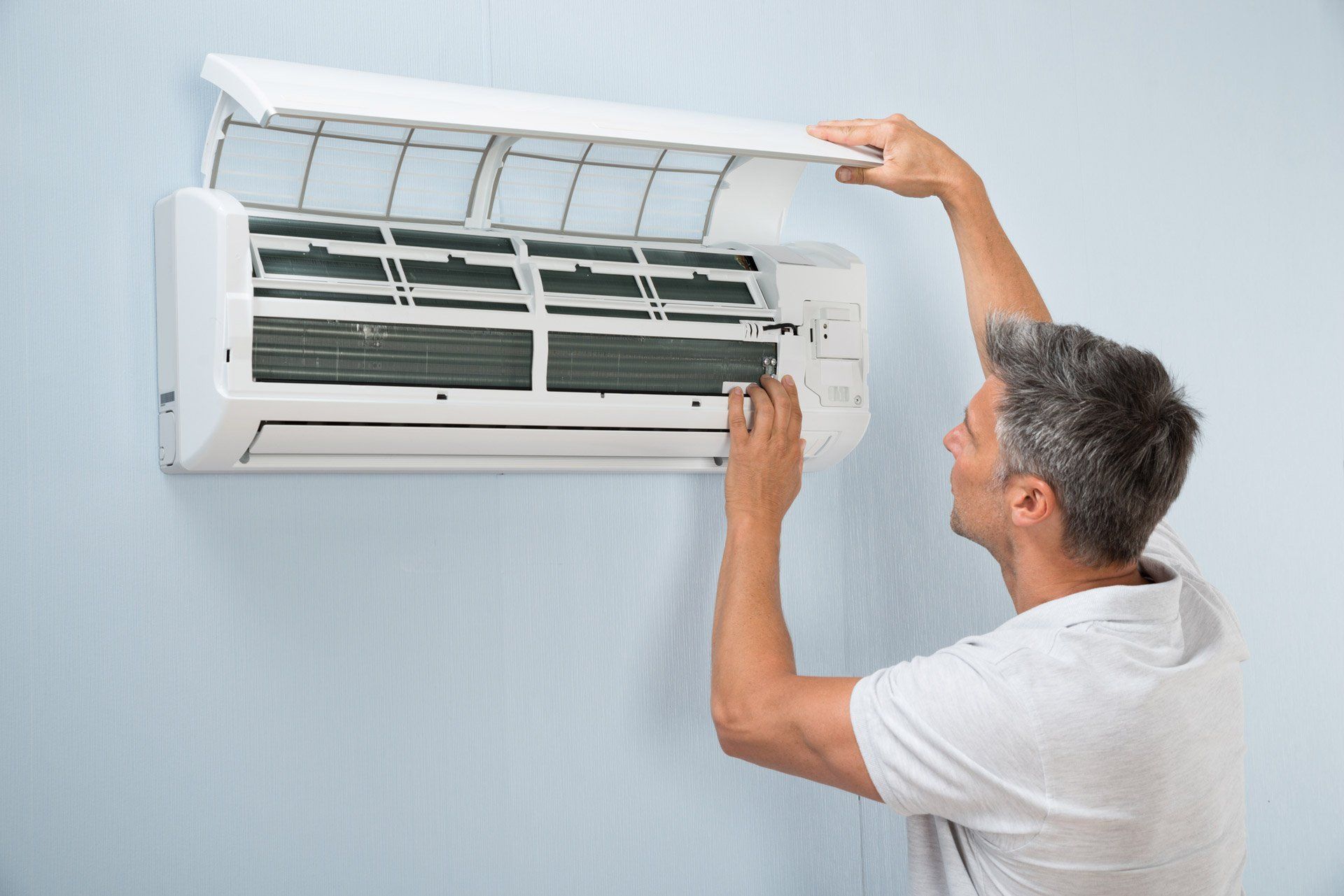 man installing an AC unit