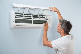 man installing an AC unit air conditioning repair & installation services Nashville, NC