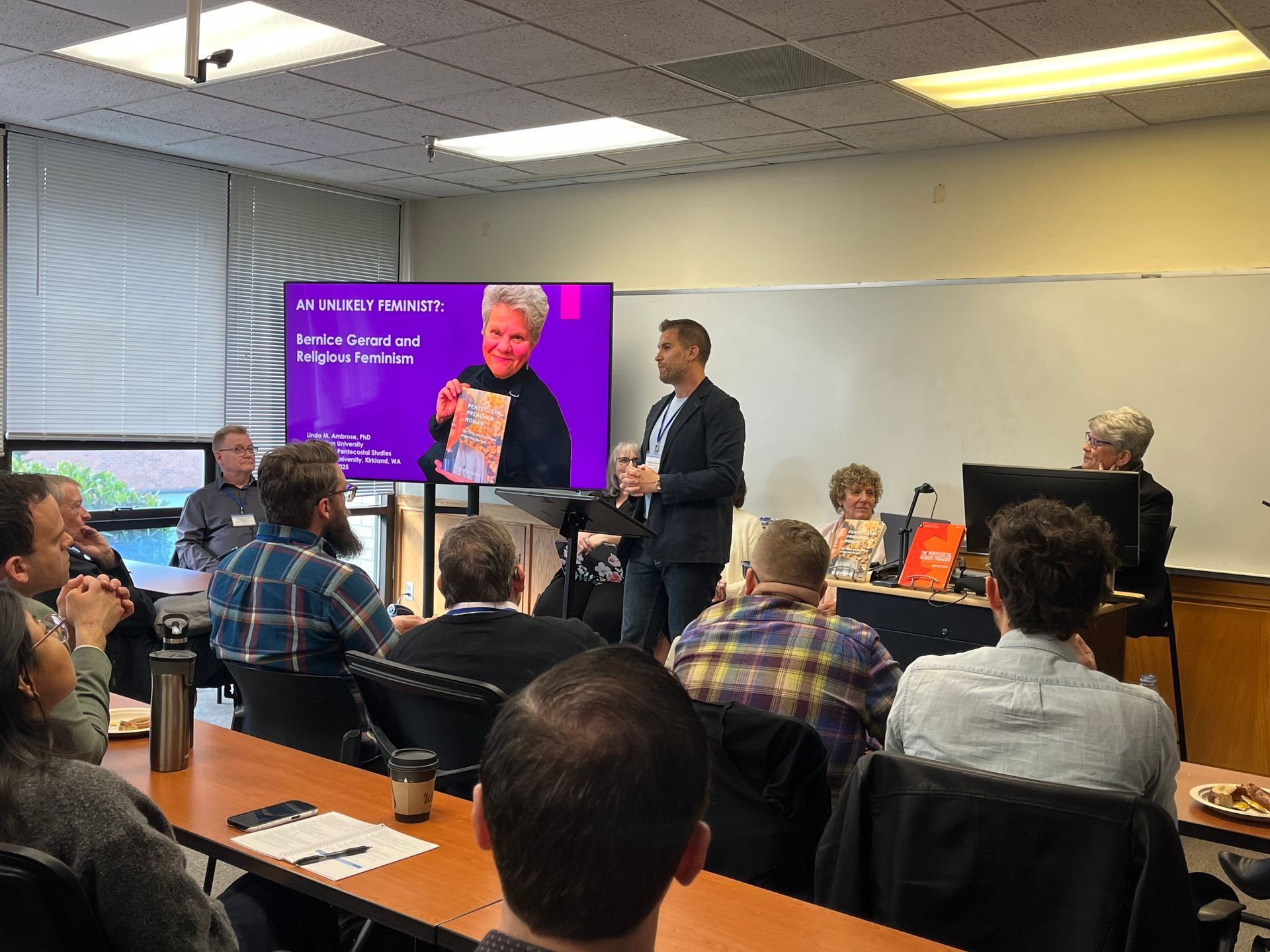 Joseph Dutko presenting at a conference, along with the other panelists.