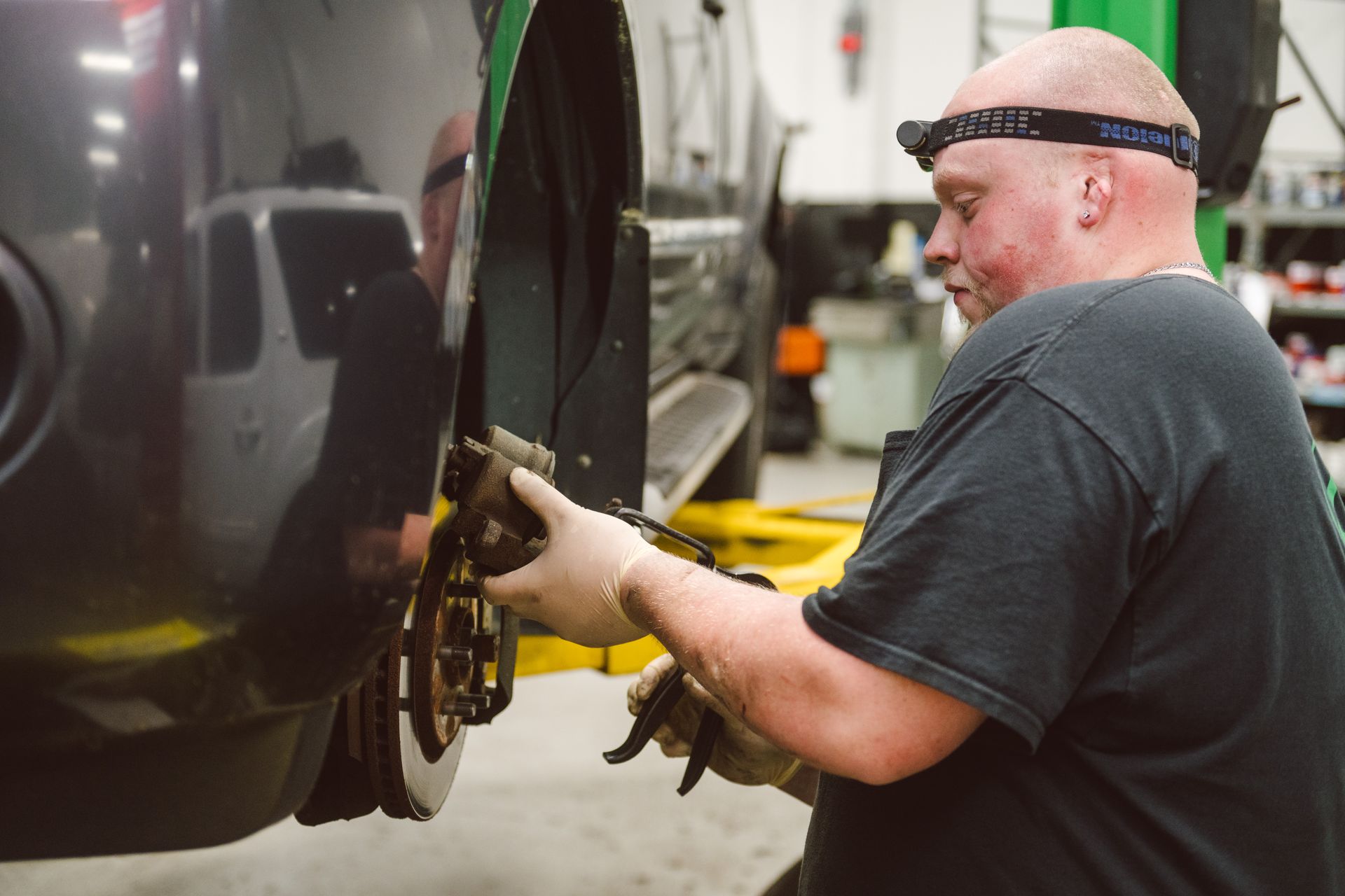 technician inspects brakes