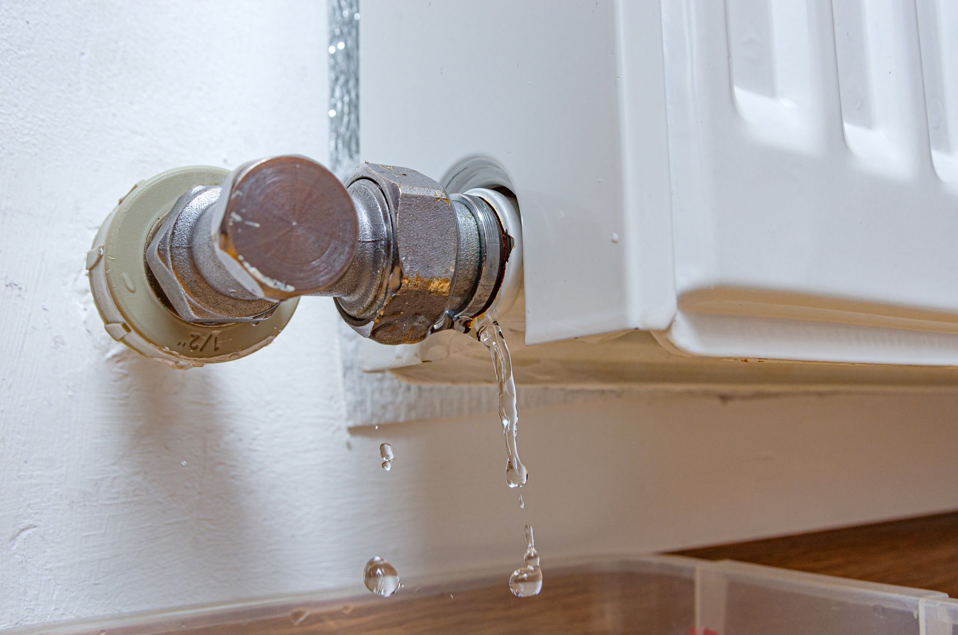 Radiator valve leaking water onto the floor.