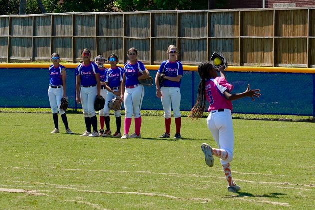 Baseball player sliding into home plate, catcher in front. Blue and gold uniforms, action shot.