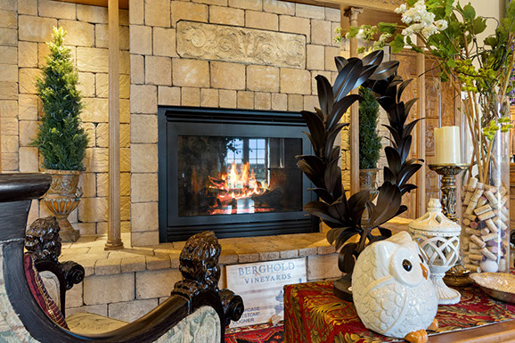 A living room with a fireplace and a statue of an owl.