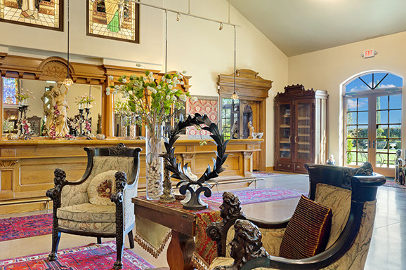 A living room with chairs , a table and a bar.