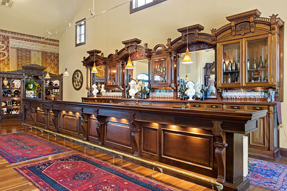 There is a long wooden bar in the middle of the room.