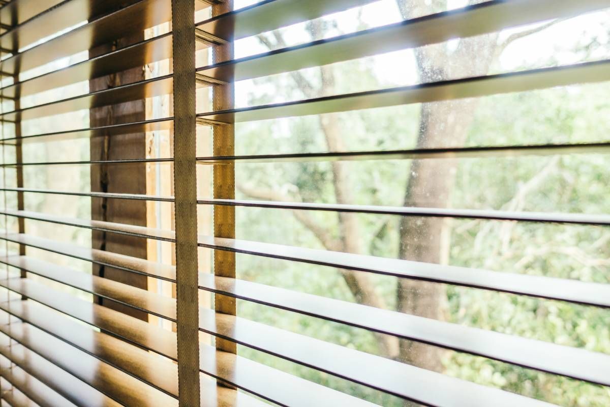 Wood blinds on an odd-shaped window at Blinded By Delight near San Antonio, TX