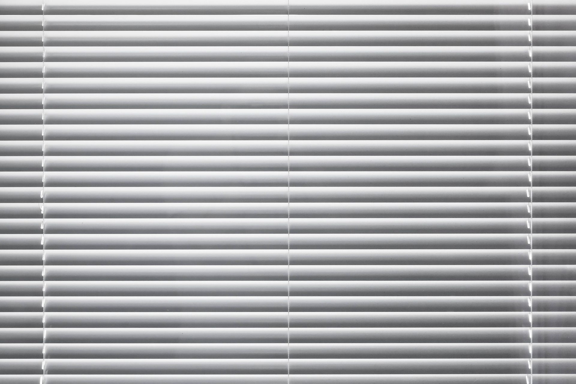 Modern white window blinds during the day at Blinded by Delight Window Coverings & Design near Boern