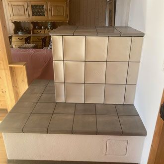 Treppe mit dunkelgrauen Steinstufen und Podest, Metallgeländer und einem Fenster mit Blick ins Grüne.